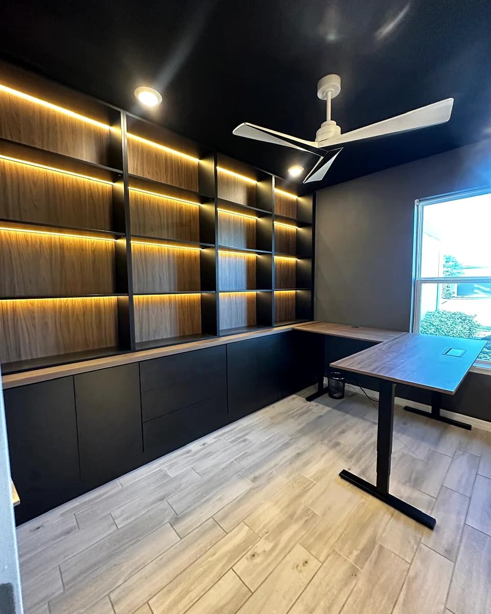 Finished dark home library with warm integrated lighting