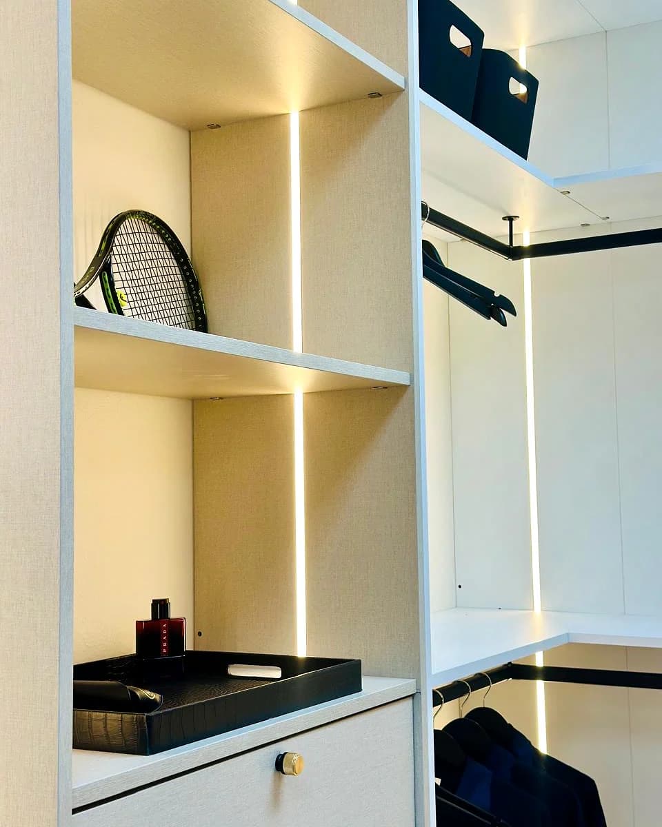 Wardrobe interior showing shelves, hanging storage and integrated lighting