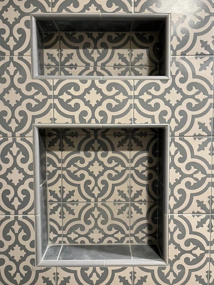 Patterned shower-wall tile around two gray-tiled recessed niches in a La Jolla bathroom remodel