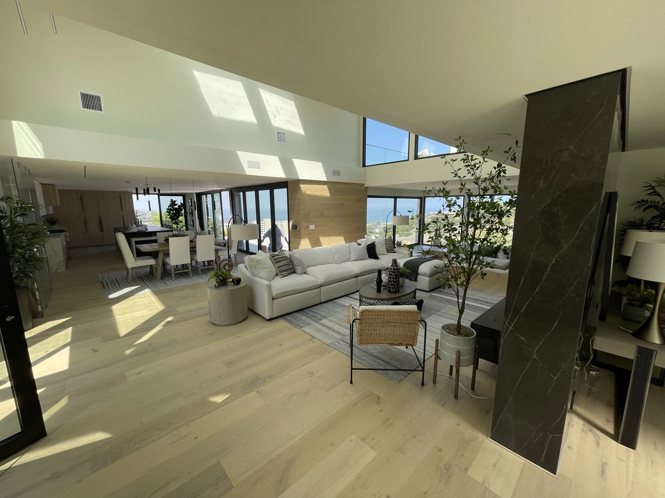 Completed open-plan home with white-oak flooring, expansive glazing, and coordinated living spaces