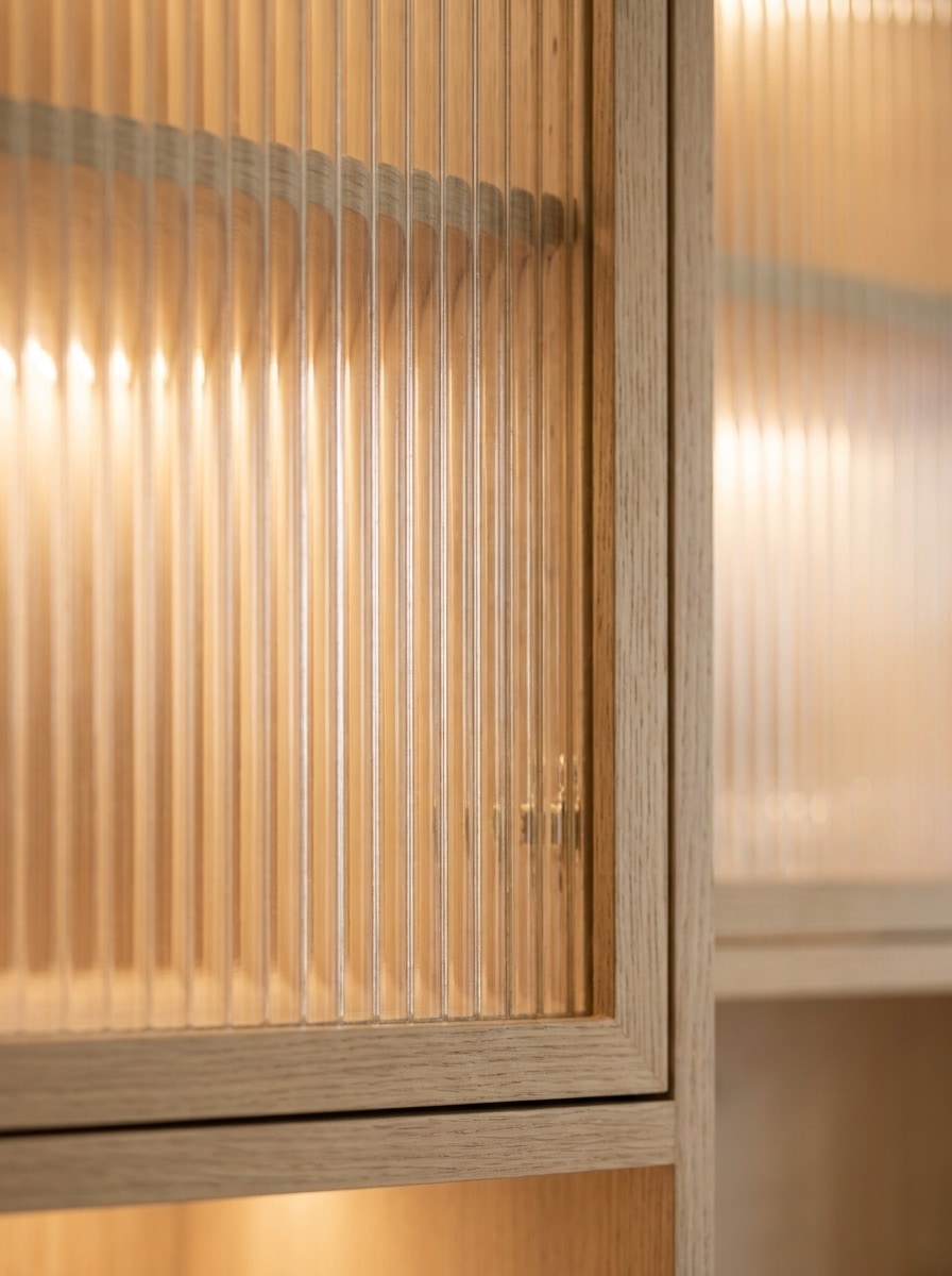 Concept study of a reeded glass cabinet panel in a white oak frame