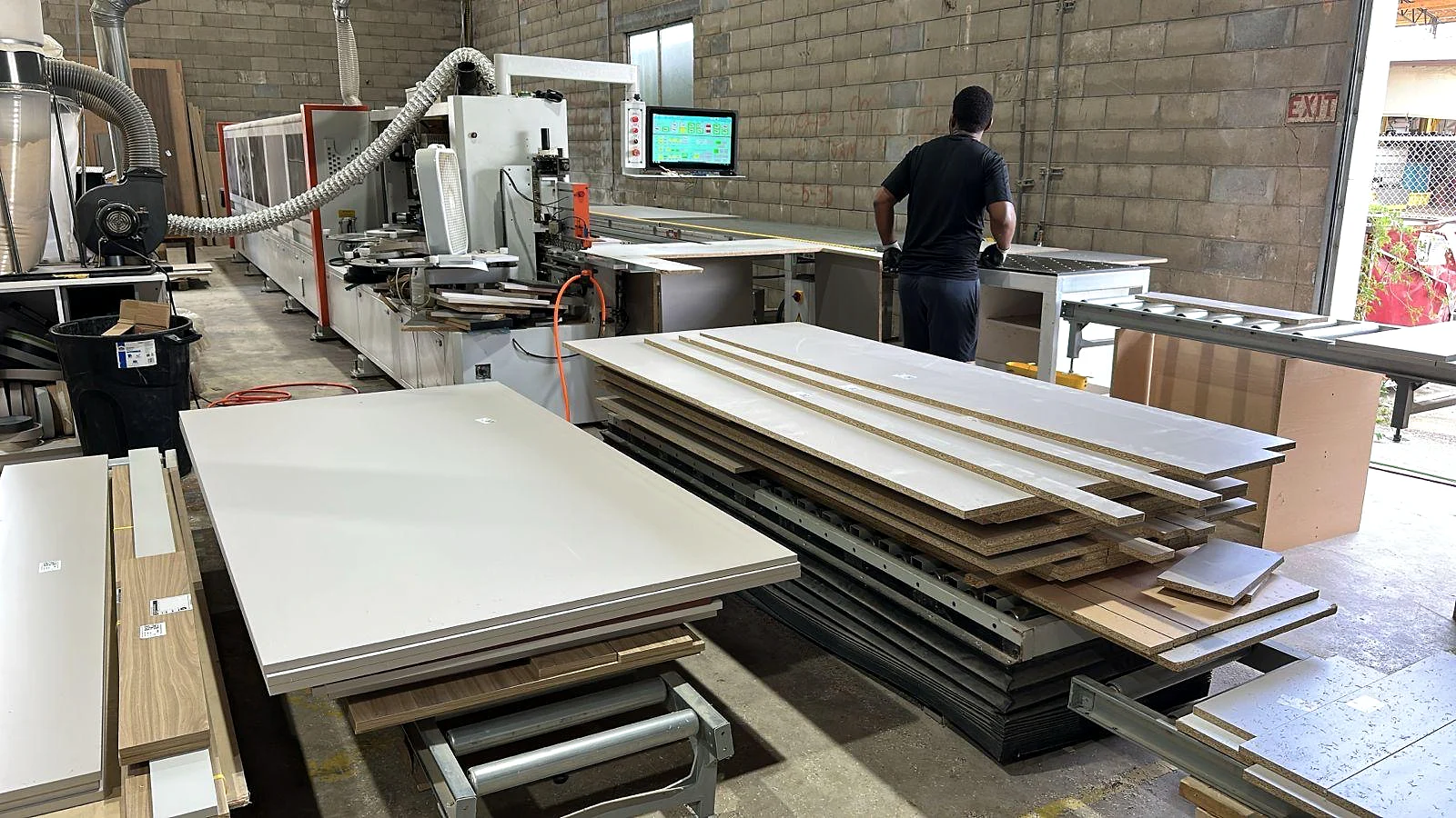 Cabinet panels moving through a precision fabrication line