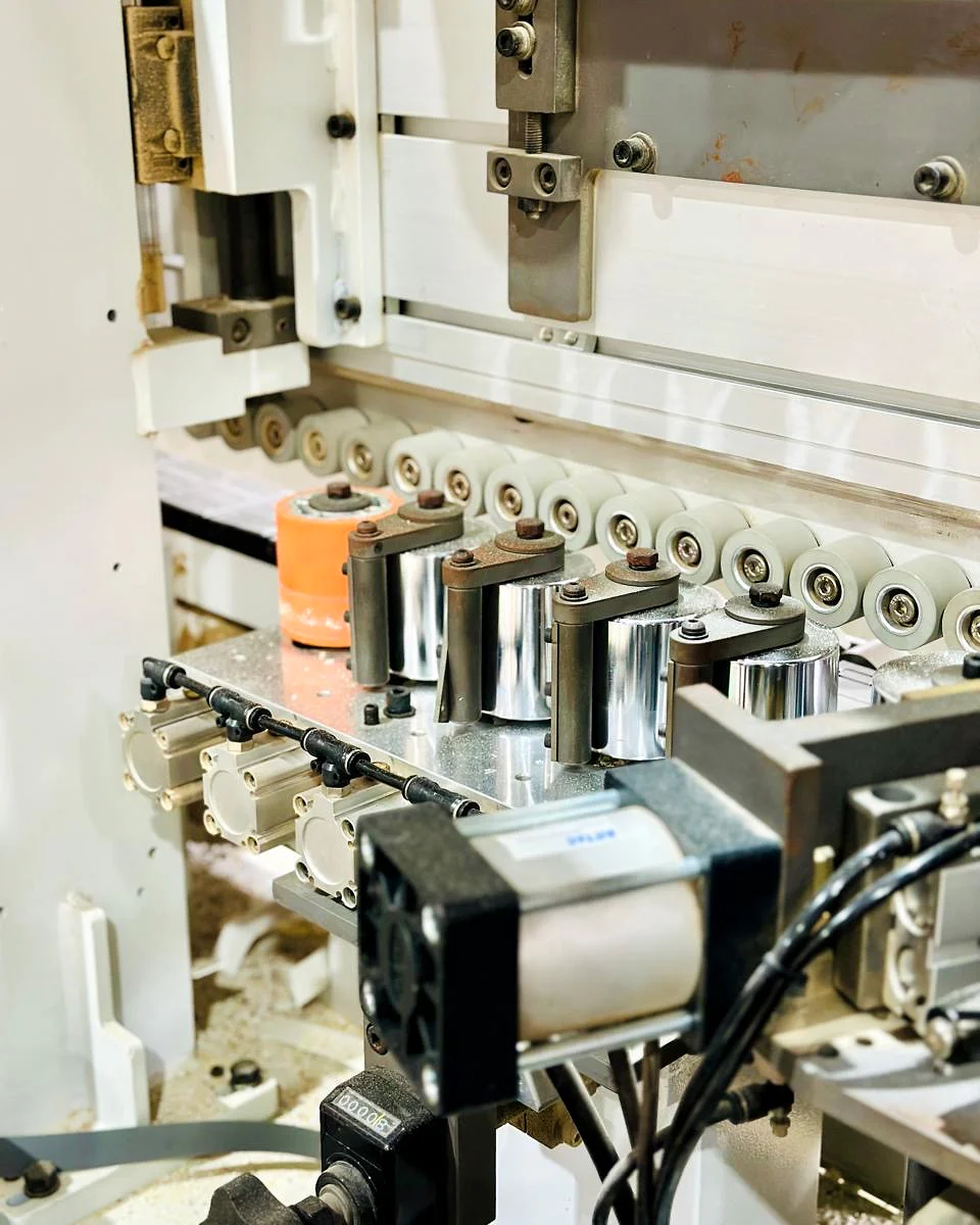 Close view of cabinet fabrication machinery at work