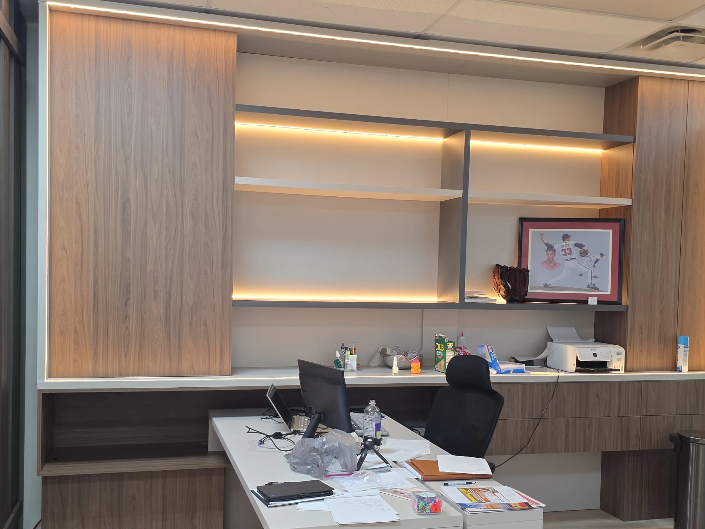 Custom office built-ins with desk and illuminated shelves