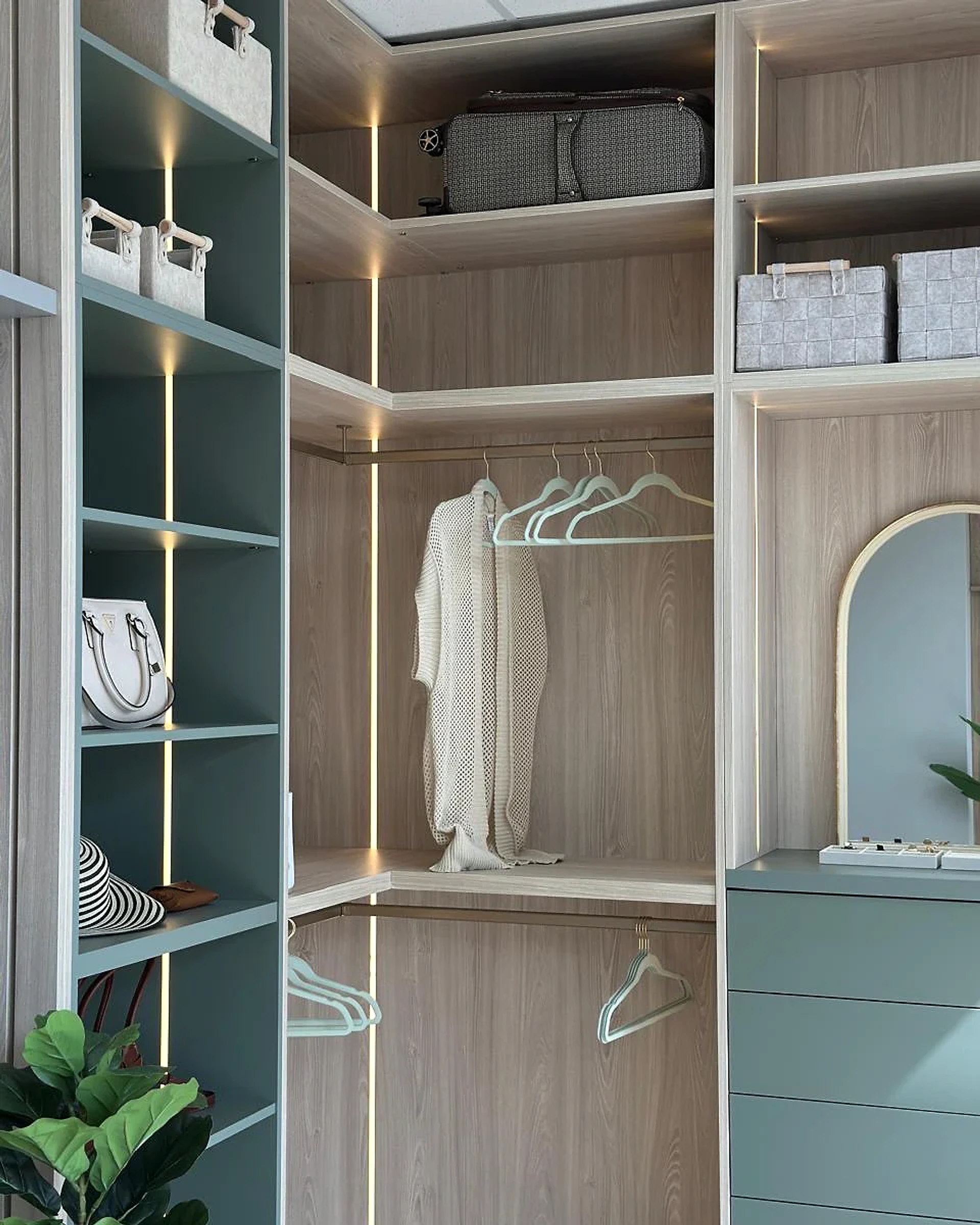 Walk-in wardrobe with lit shelving, hanging storage and drawers