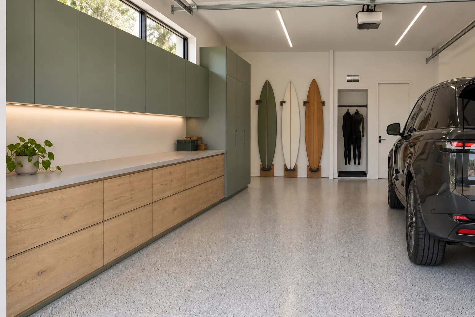 Proposed after concept of the garage with coordinated cabinets, surfboard storage and an open coated floor