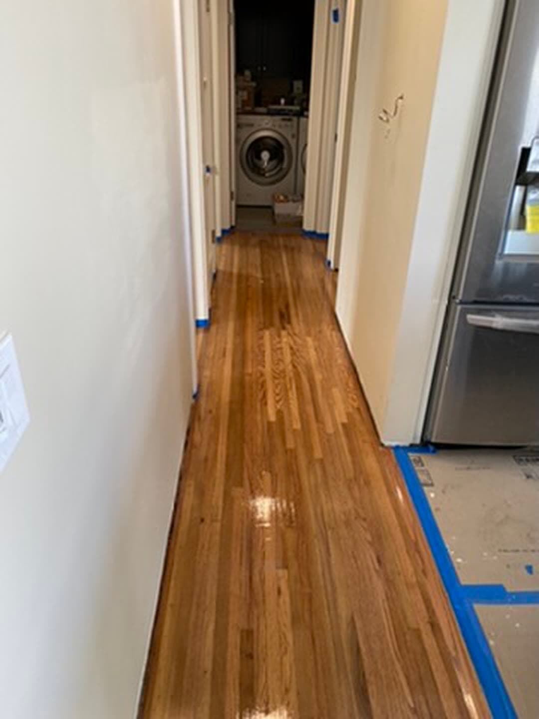 The same hallway after sanding and refinishing, even color and sheen