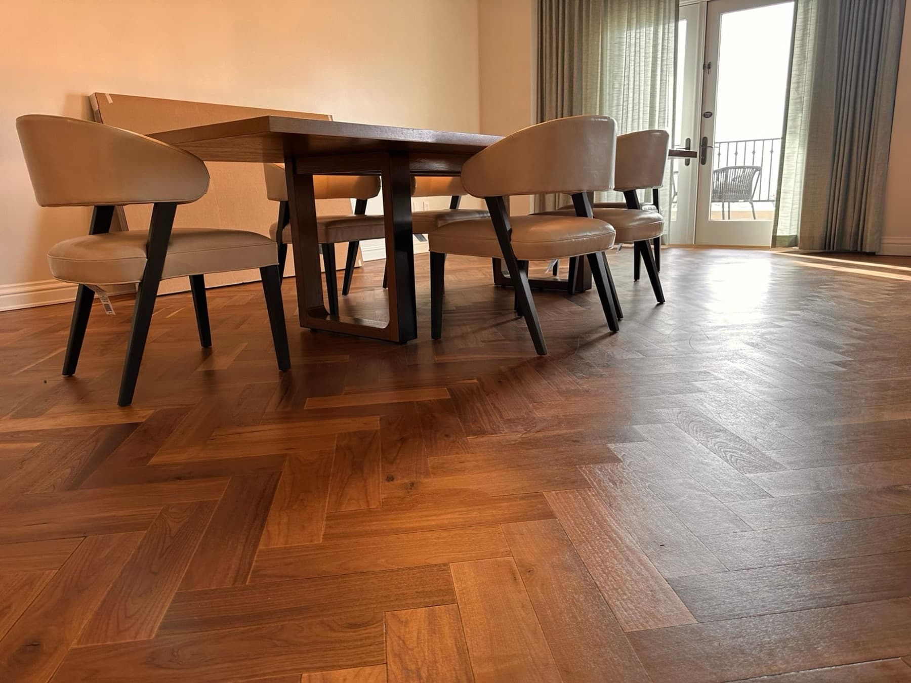 The same herringbone floor finished, with a dining table on it