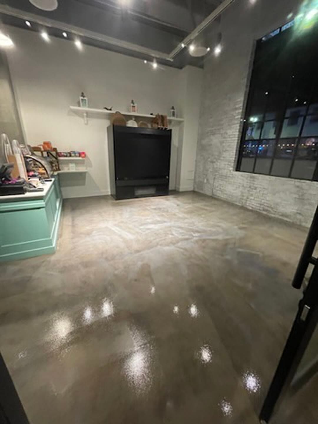 The same retail floor sealed, reflecting the ceiling lights