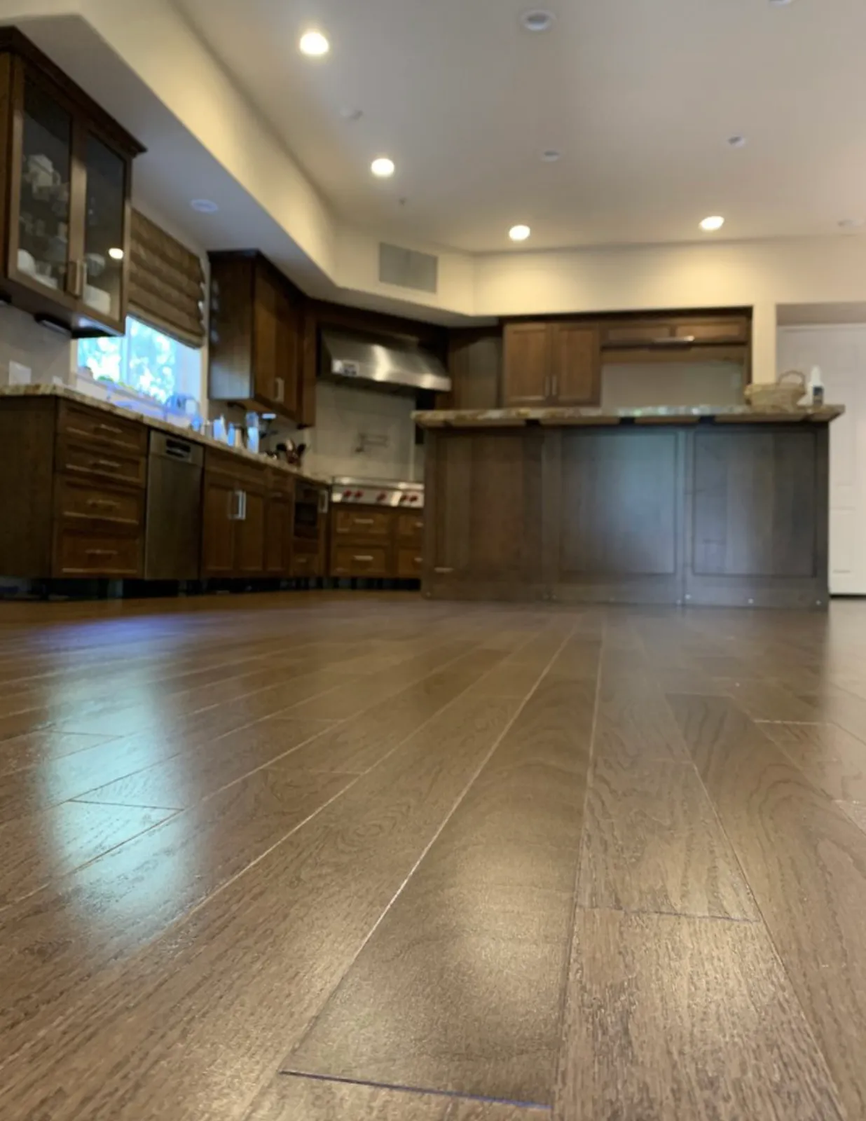 Dark wood kitchen with a long island and new hardwood floor