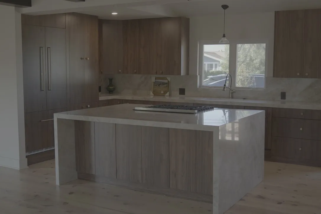 Wood kitchen with a stone waterfall island