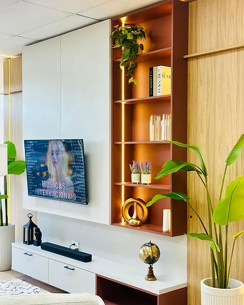 Showroom media wall with a rust-colored open shelf and a light strip