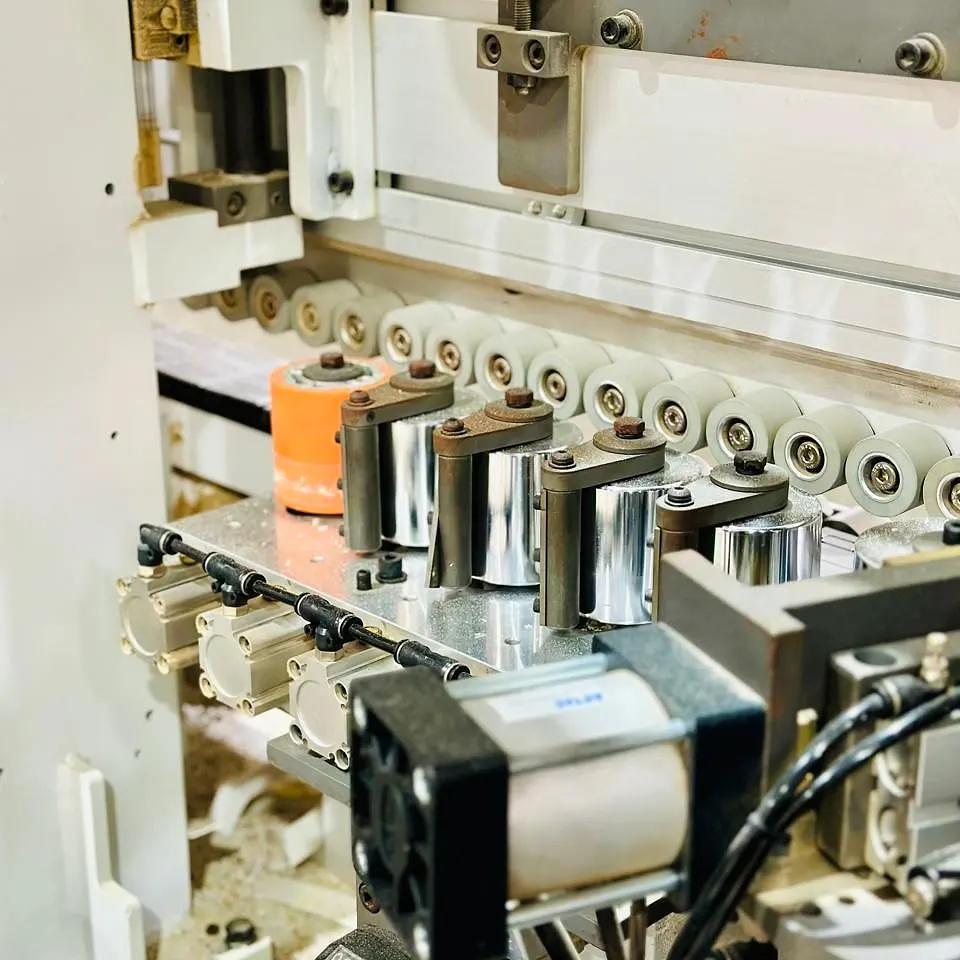 Close view of rollers and cylinders inside a workshop machine